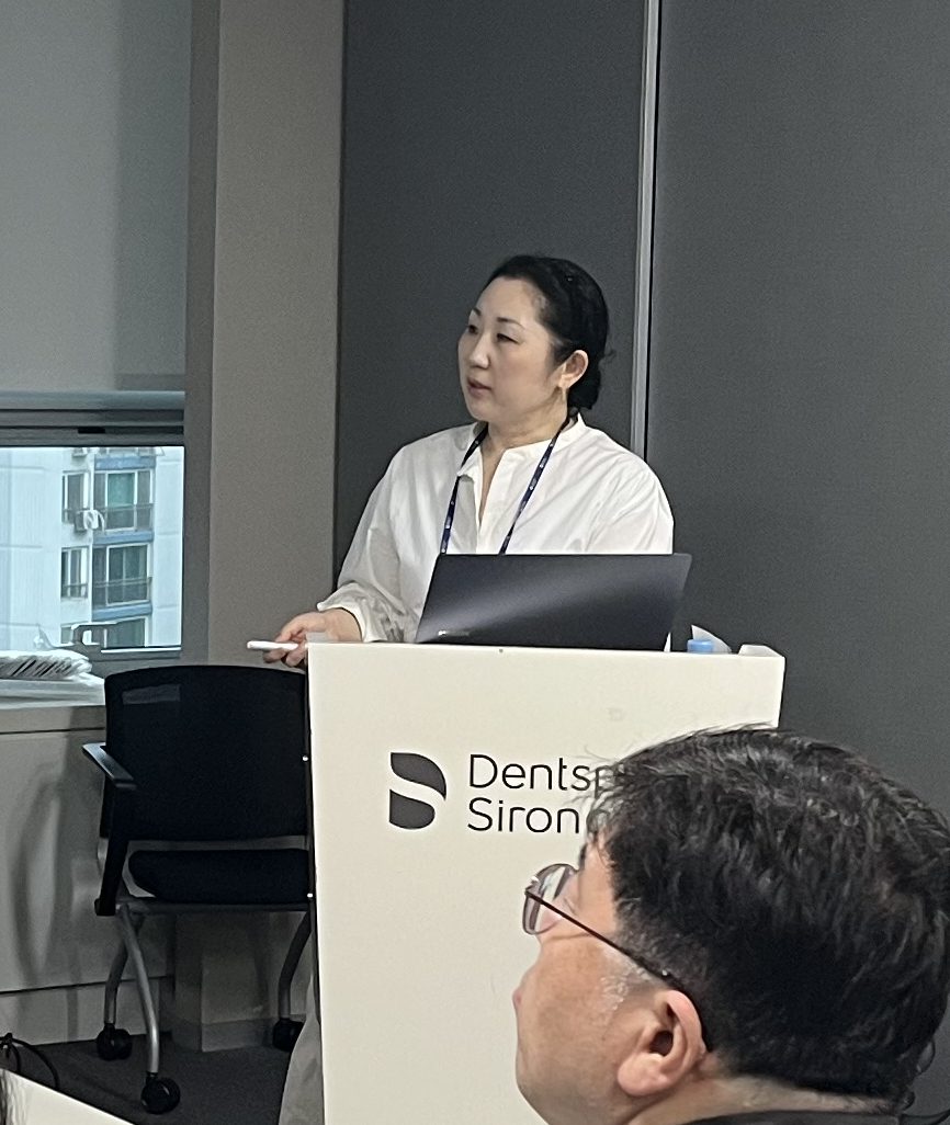 Dr. Keun-Hye Lee lecturing on clear aligner treatment at a 2026 SureSmile seminar